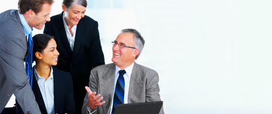 Business Professionals gathered around a computer